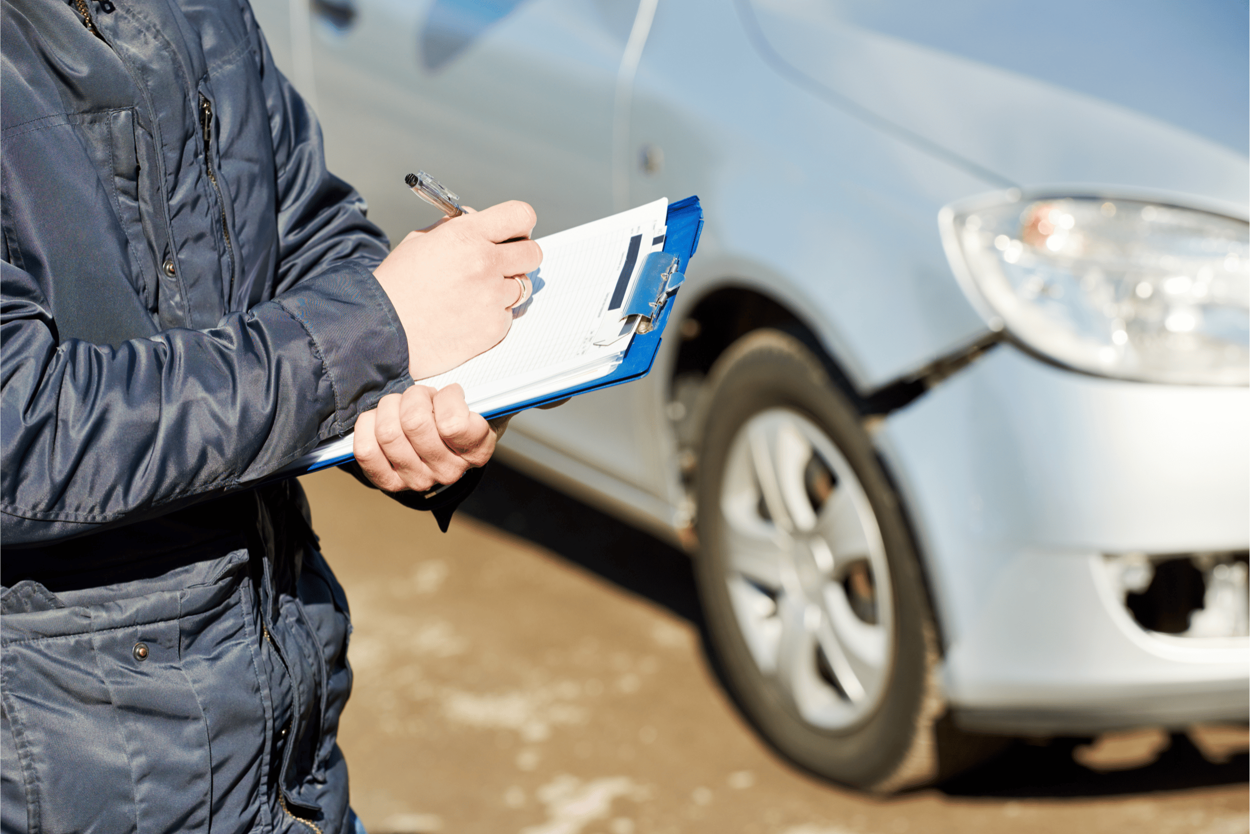 an agent marking car damage