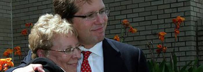 Client happily hugging Mark Lanier
