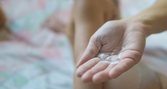 talc powder on female hand