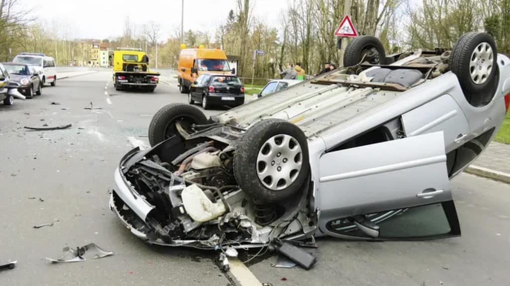 a car flipped on its side after an accident