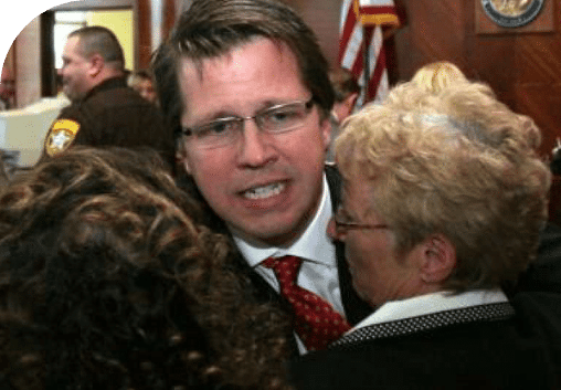 clients hugging Mark Lanier