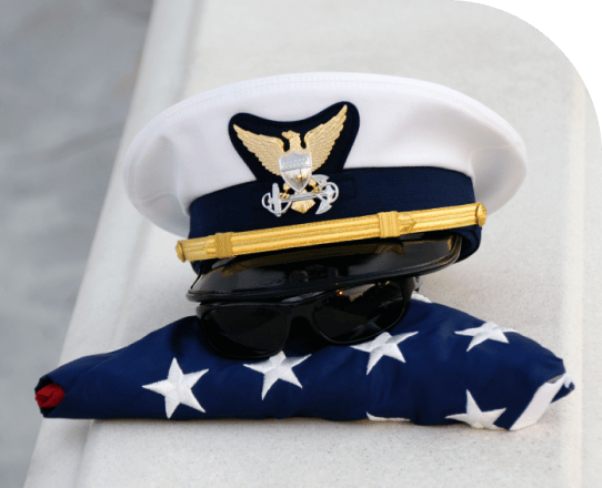 a coast guard hat on top of an American flag