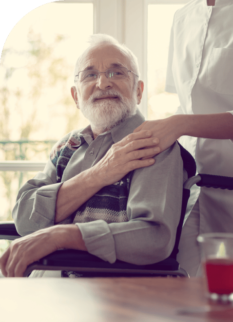 a woman comforting a man in a wheelchair