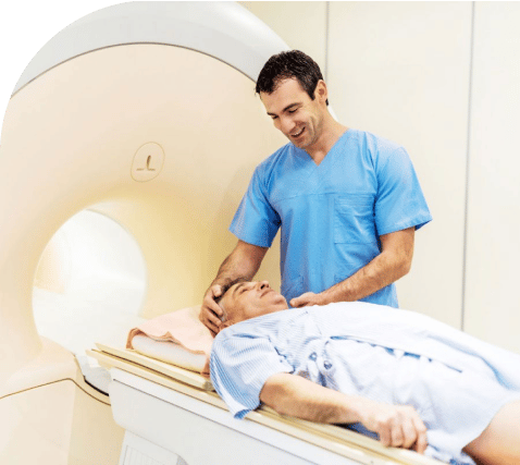 Nurse prepares older man for radiation therapy
