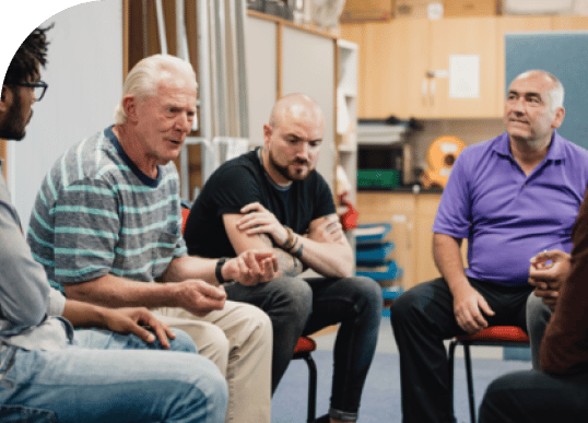 a group of men talking to eachother