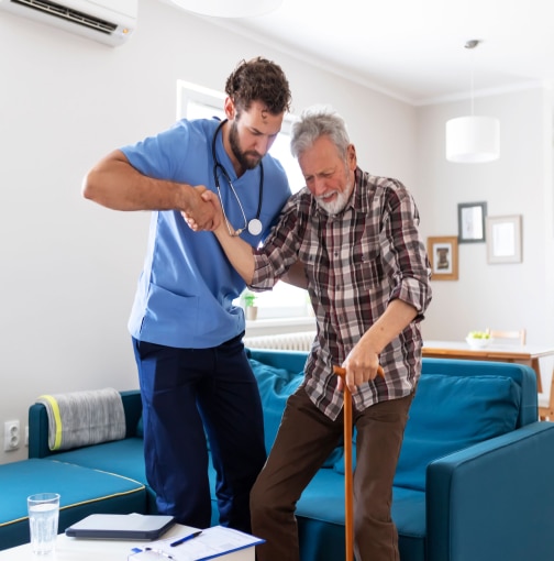 young man helping an elderly man stand