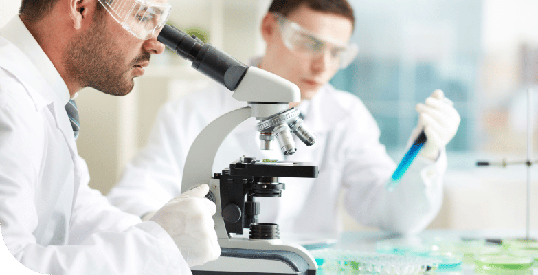 lab worker looking in microscope