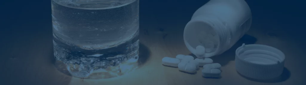 pills and a glass of water