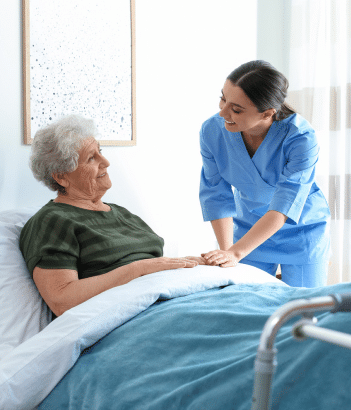 nurse comforting an elderly lady