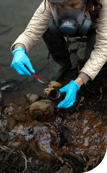 Scientist ecologist in the forest taking samples of contaminated water