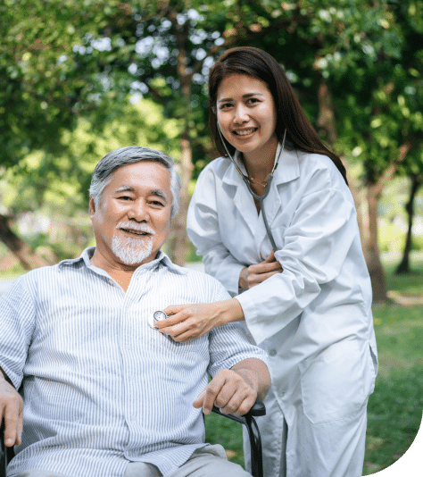 A physician using a stethoscope to check an elderly man's heart, monitoring his cardiovascular health.