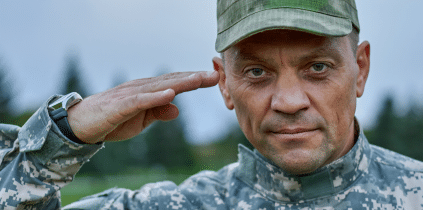 A military man in uniform saluting, showing respect and dedication to his country.
