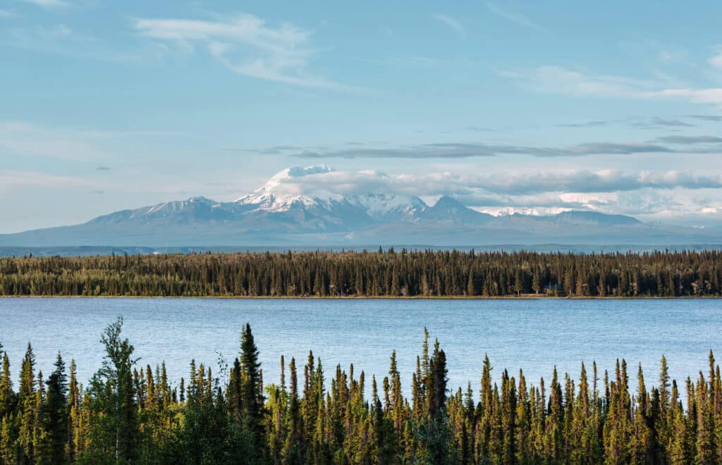 Picturesque Mountains of Alaska in summer. Snow covered massifs, glaciers and rocky peaks. Beautiful natural background.