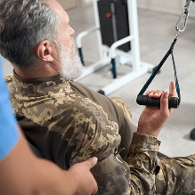 Army veteran doing rehabilitation work in a gym