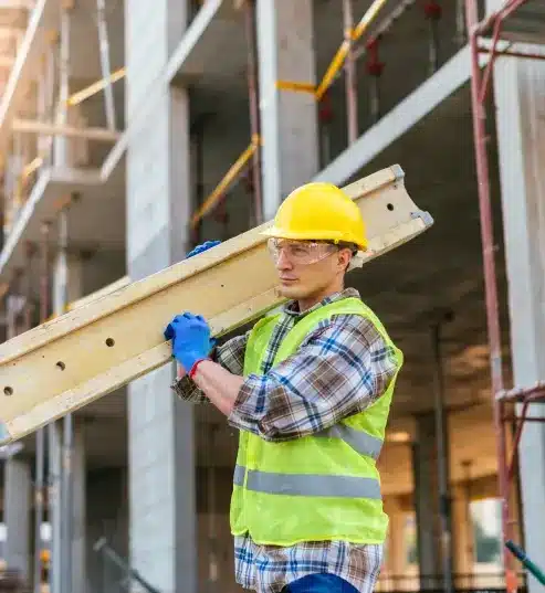 Construction worker with a yellow cap and security vest in construction site