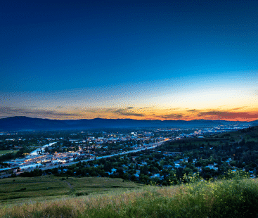 View of a city in Montana from a hill at twilight