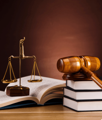 Wooden gavel with books and the scales of justice