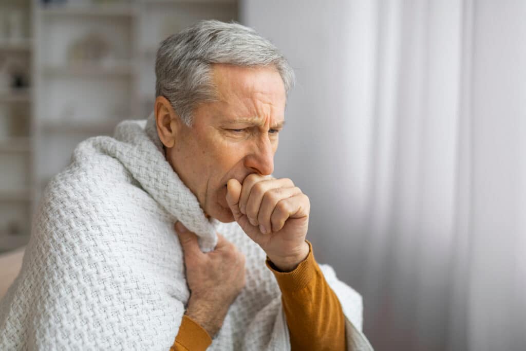 Man Coughing From Mesothelioma Symptoms
