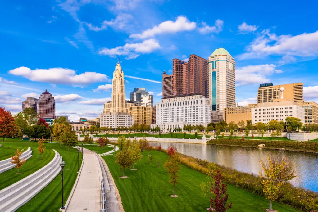 Skyline of Columbus, Ohio, showing tall buildings and a clear view of the urban city center and Scioto River