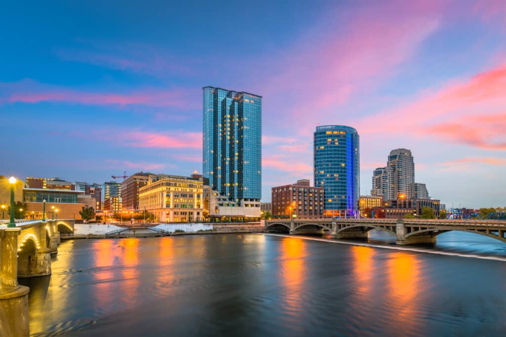 Grand Rapids, Michigan, USA downtown skyline on the Grand River at dusk.