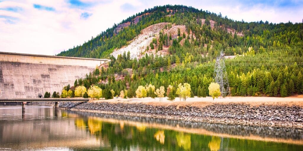 Libby dam with road, power lines, and wilderness, near the town of Libby and vermiculite mines with asbestos