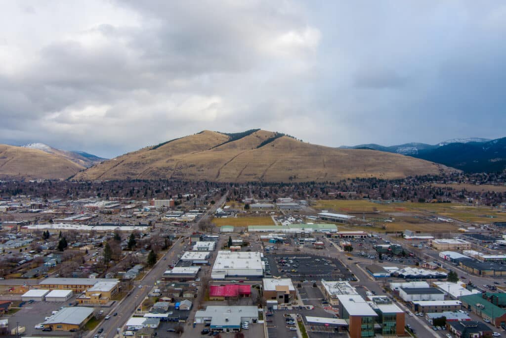 Missoula, Montana city’s landscape surrounded by mountains and greenery.
