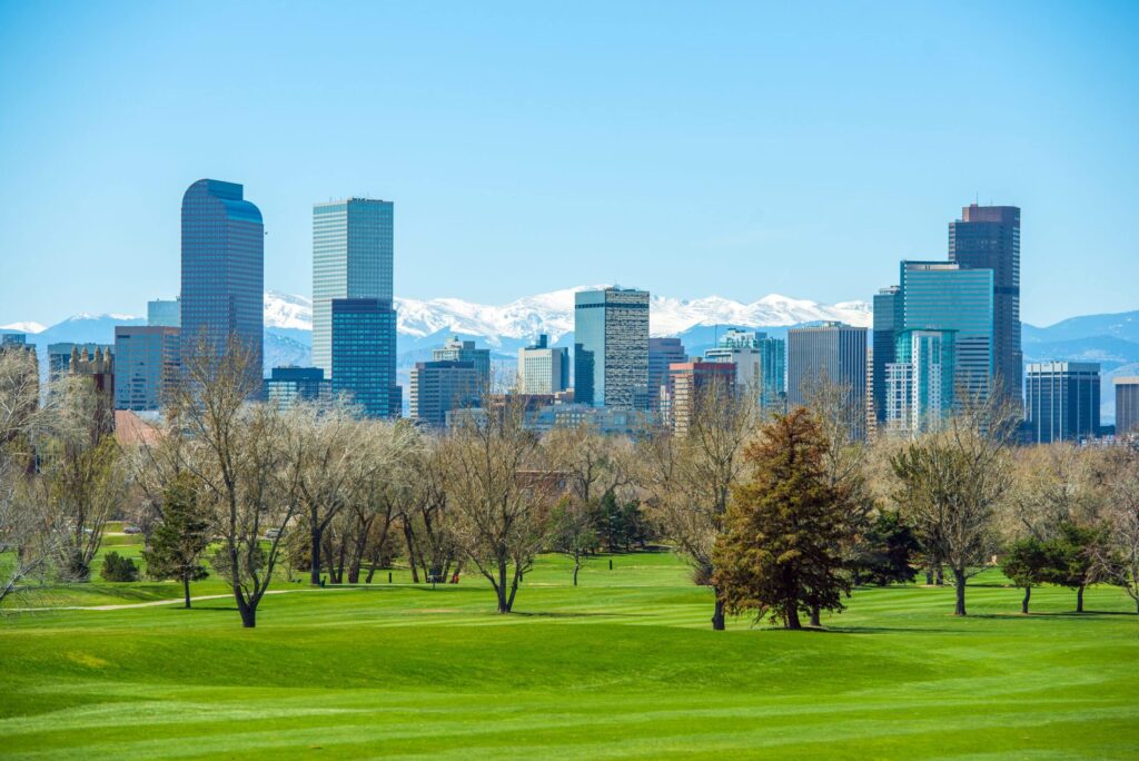 Sunny Denver Skyline. Spring in Colorado. Denver Skyline and Snowy Rocky Mountains.