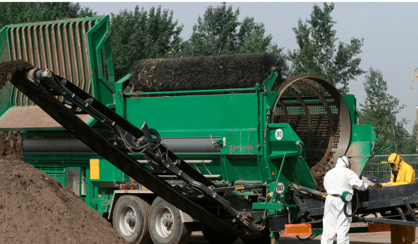Workers wearing protective equipment at an asbestos exposure site