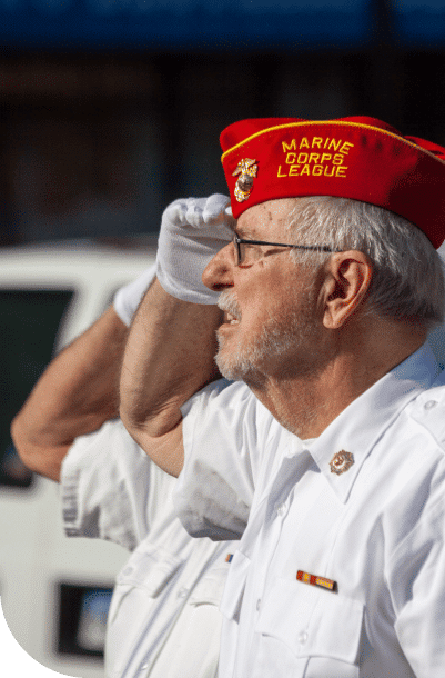 Senior U.S. marine corp veteran saluting the flag