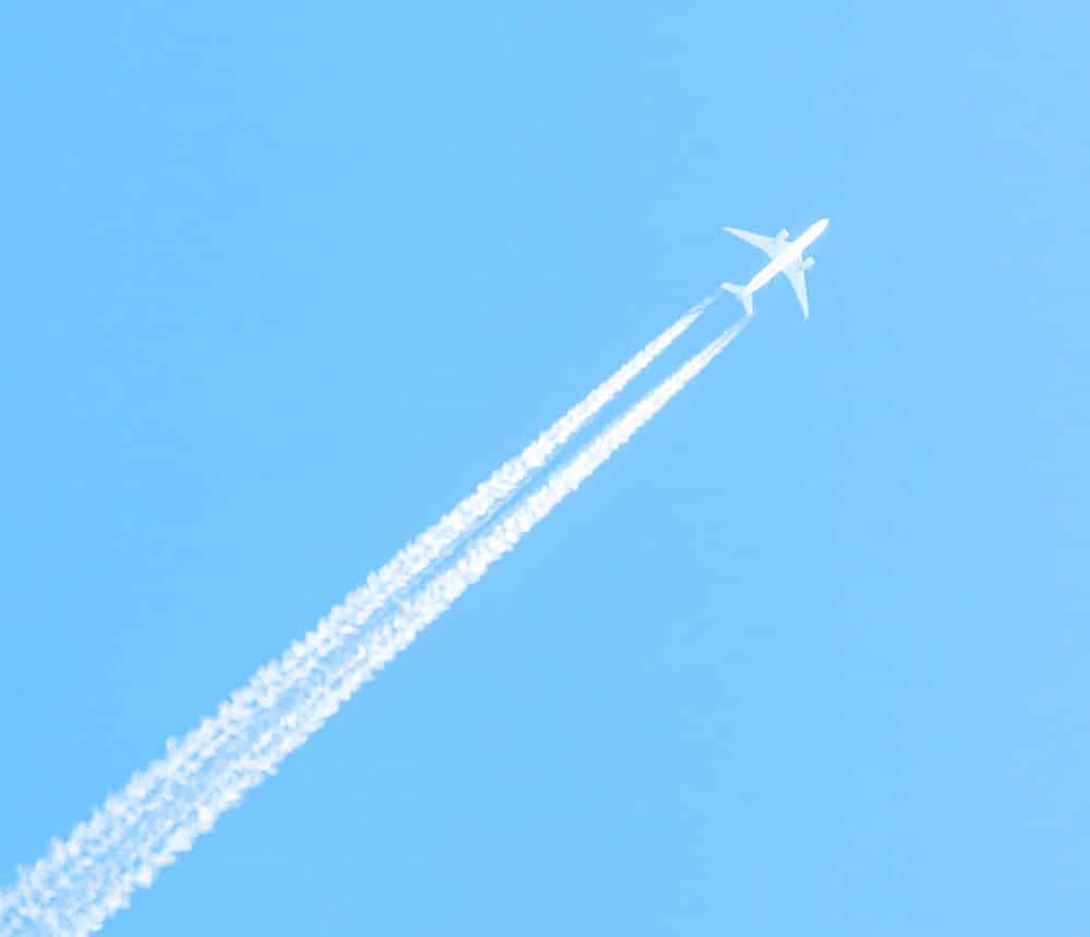 A plane on a blue sky leaving a trail