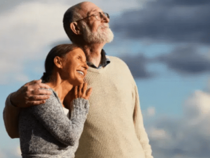 Happy couple smiling up toward sky