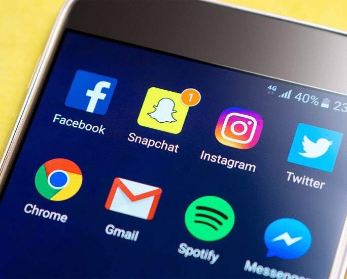Phone with social media app icons representing Meta (Facebook and Instagram) lawsuit