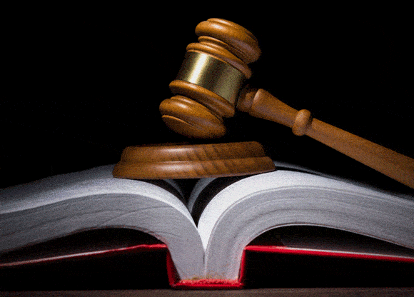 Wooden gavel on top of an open law book