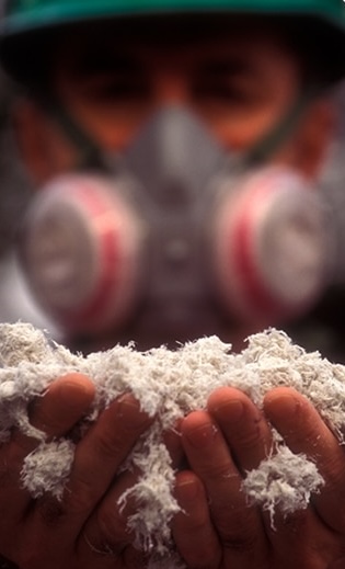 Worker holding asbestos fibers with both hands