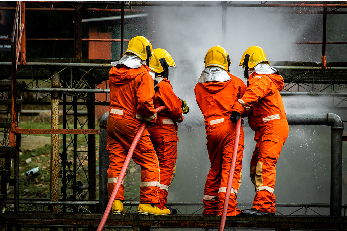 Firefighters hosing down a building that was in flames