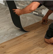 Worker setting asbestos-containing vinyl flooring