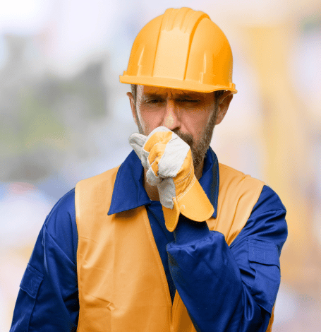 Construction worker coughing after inhaling asbestos fibers