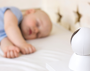Baby monitor in front of a sleeping toddler