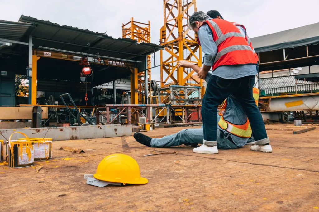 Worker being dragged to a safe location after suffering a type of industrial accident