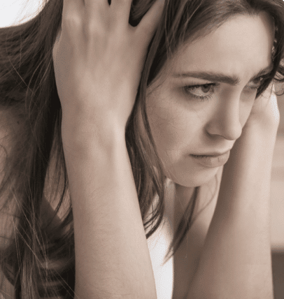Young female teenager holding her head