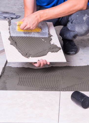 Contractor Laying Asbestos Containing Tile Flooring