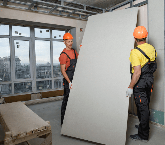 Men handling asbestos containing drywall