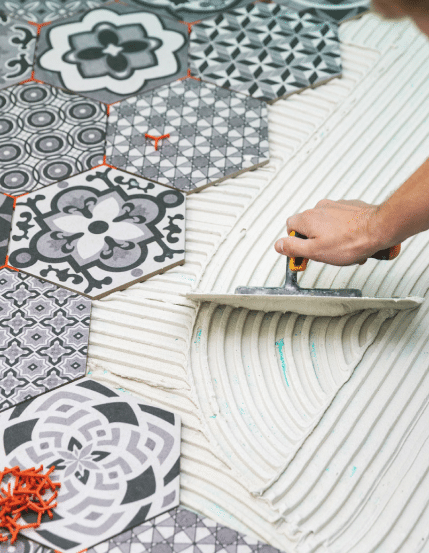 Black and White Asbestos-Containing Tile Flooring Being Installed
