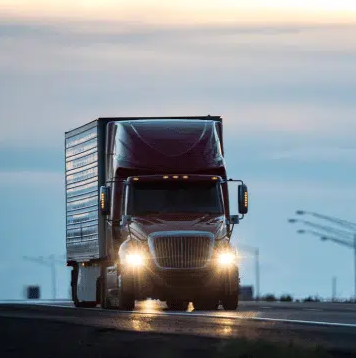 Red truck with headlights on