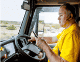 Truck driver looking at a cell phone