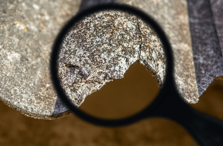 Asbestos-Containing Roofing Tile Under Magnifying Glass