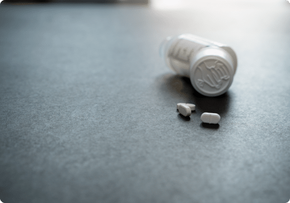 Prescription bottle and pills on a table