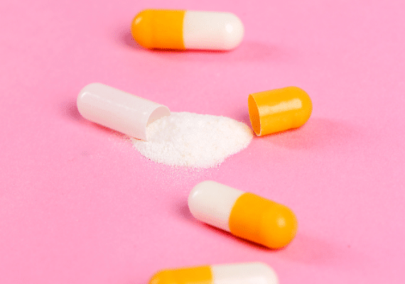 Open capsule and drug powder content on a table