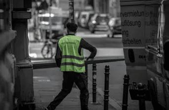 Construction worker with safety jacket in an urban setting