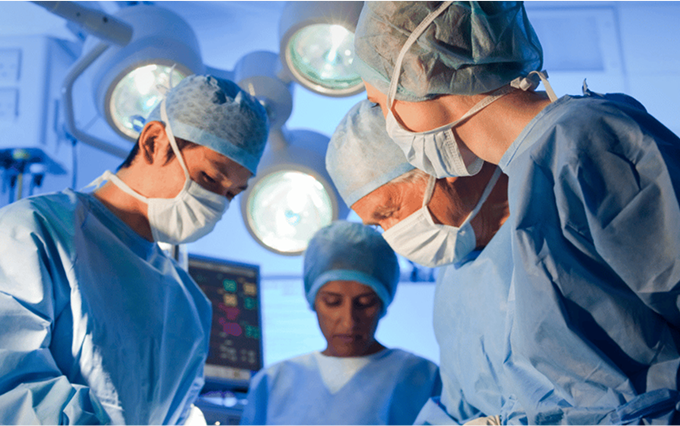 Four doctors operating on a mesothelioma patient